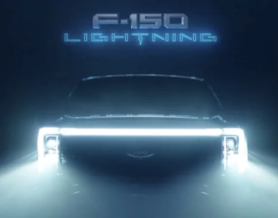 Ford F-150 Lightning Latest 2022 F-150 Lightning EV Teaser Closes In On Front Light Bar and Grille F-150-Lightning-teaser.png