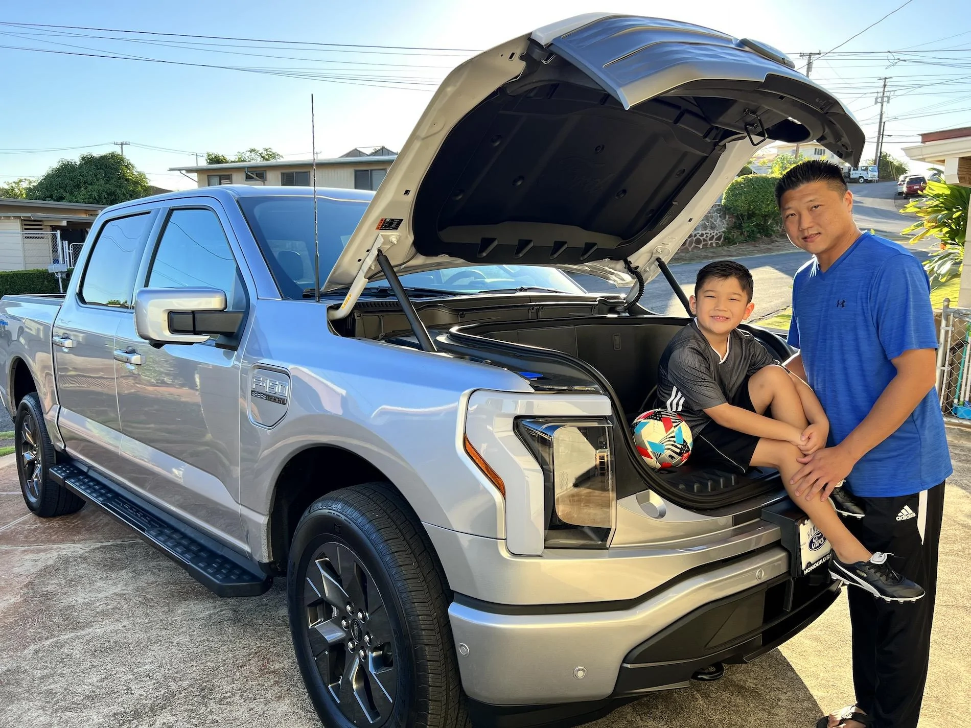 Ford F-150 Lightning Lightning Strikes Across America: Customer Deliveries Now Stretch Across All 50 States Aaron and son posing in front of Lightning