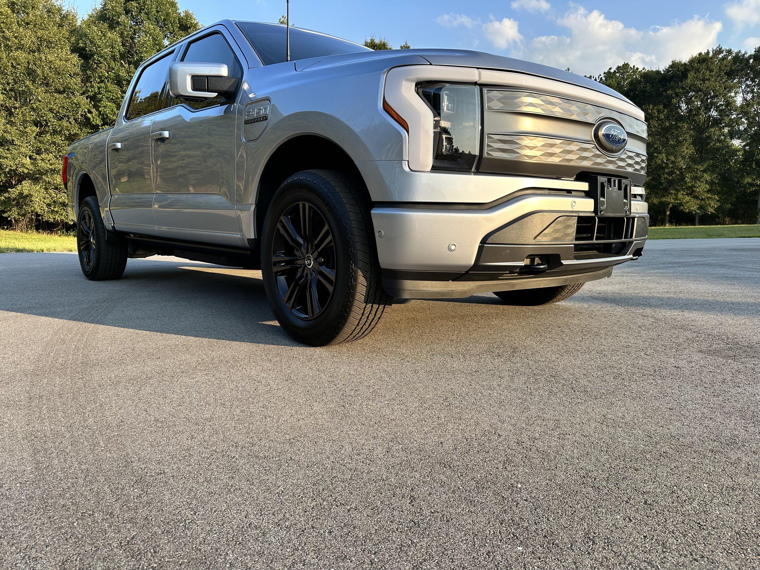 Ford F-150 Lightning Gloss black 20" wheels on my Lightning Lariat with stock AT tires, tints, AMP Power Steps EE623F0A-75A5-43B6-AB15-9B7AD59A79B3