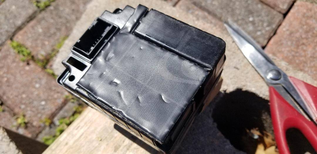Mach E shifter - bottom with rectangular protrusion leveled with Dynamat 3 layers.jpg